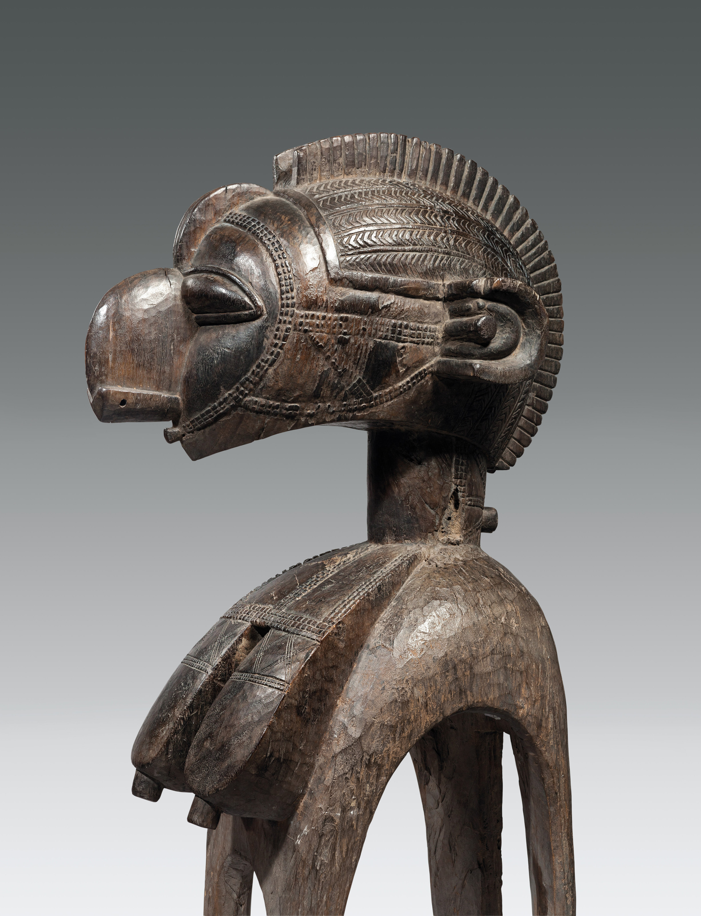 D’Mba mask worn on the head with raffia costume